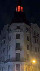 Woman walks through illuminated Saint Petersburg streets at night