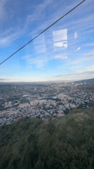 Cable car ride captures Tbilisi landmarks on clear day