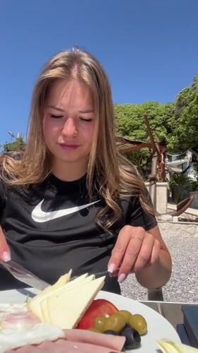 Woman enjoys seaside breakfast in Prijevor, Montenegro