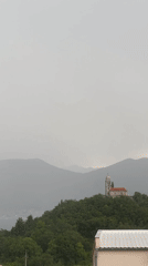 Witness Documents Overcast Hilltop Church and Mountain Landscape