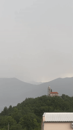 Witness Documents Overcast Hilltop Church and Mountain Landscape