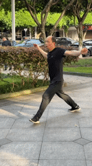 Man practices Tai Chi in waterfront park, Jiangjin China
