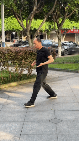 Man practices Tai Chi in waterfront park, Jiangjin China