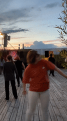 Rooftop dance party captured at dusk in Tbilisi