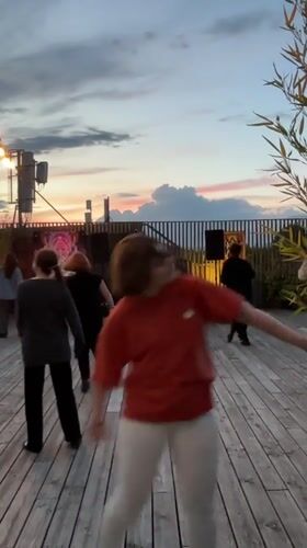 Rooftop dance party captured at dusk in Tbilisi