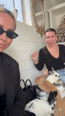 Two women visit rabbit enclosure in Solana Beach