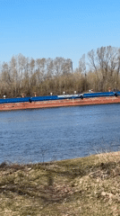 Commercial barge travels river near Chaikovsky, Russia