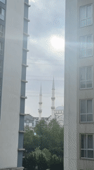 Morning view of mosque glimpsed between Esenyurt apartment buildings