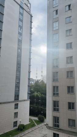 Morning view of mosque glimpsed between Esenyurt apartment buildings