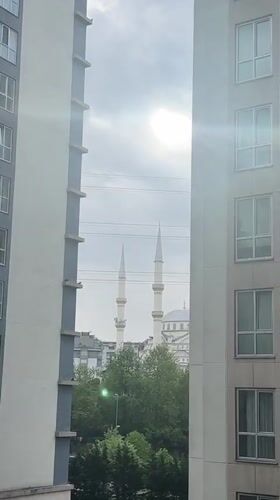 Morning view of mosque glimpsed between Esenyurt apartment buildings