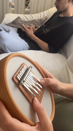 Young man plays kalimba indoors in Sevastopol