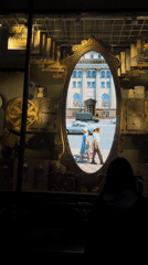 Person views vintage shop display with video mirror in Minsk
