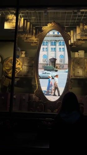 Person views vintage shop display with video mirror in Minsk