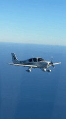 Cirrus SR22 flies over coastal waters near Summerland, CA