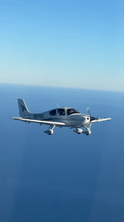 Cirrus SR22 flies over coastal waters near Summerland, CA