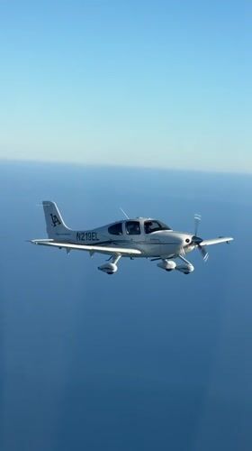 Cirrus SR22 flies over coastal waters near Summerland, CA