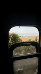 Train passenger films coastal scenery near Đà Nẵng