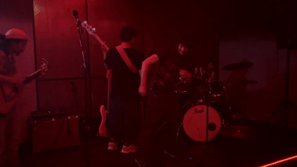 Four-piece band performs intimate concert in red-lit Milan venue