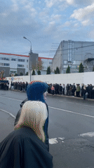 Long queue forms on wet street in Khimki, Russia