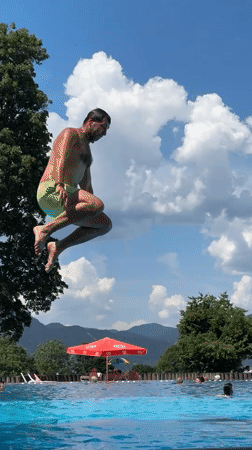 Summer day at Oberammergau's outdoor pool, Alps in the background
