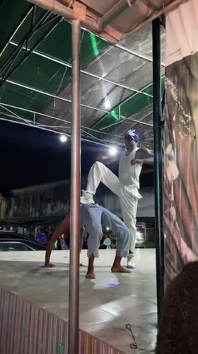 Acrobatics and fire breathing light up an outdoor Ado stage