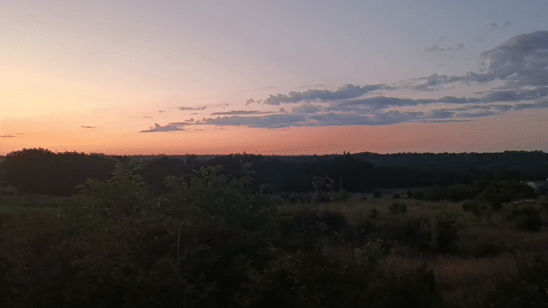 Dusk gradient sky stretches over Podilsk's open landscape.