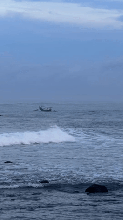 Green boat with passengers spotted near rocky coast