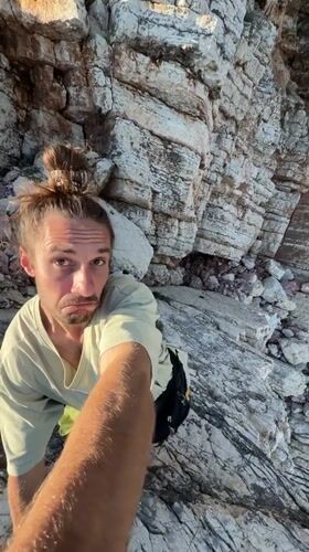 Rock climber scales seaside cliff in Montenegro