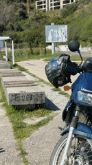 Blue Kawasaki motorcycle parked near benches in Prijevor, Montenegro