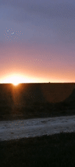 Sunset captured over open landscape with dramatic sky colors