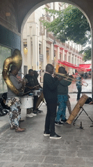 Brass band performs under covered walkway in Paris