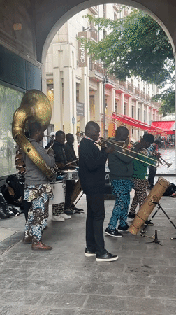 Brass band performs under covered walkway in Paris