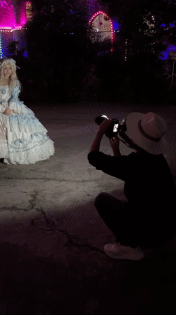 Period costume photo session at illuminated castle building