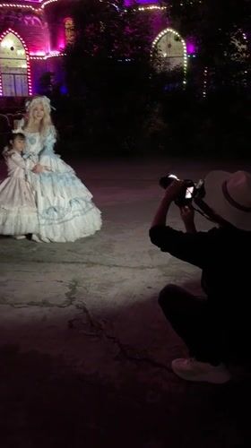 Period costume photo session at illuminated castle building