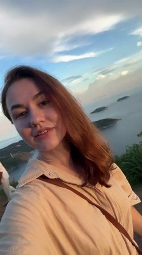 Tourist documents scenic hike and sunset views in Karon