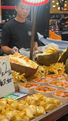 Jackfruit vendor and parked motorbikes on a Haizhu street
