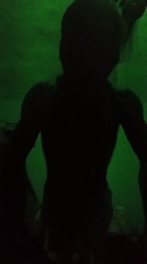 Person silhouetted in green-lit room in Nkpor, Nigeria