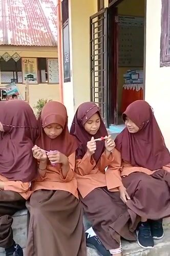 Indonesian schoolchildren documented during regular classroom and schoolyard activities