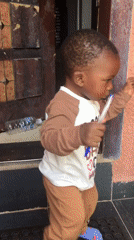 Toddler stands at doorway in Jos, Nigeria
