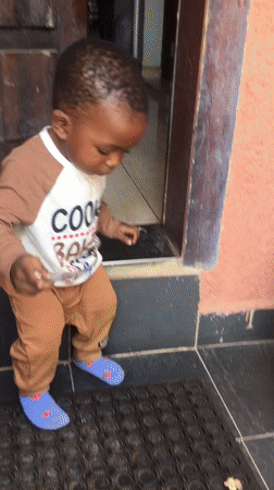 Toddler stands at doorway in Jos, Nigeria