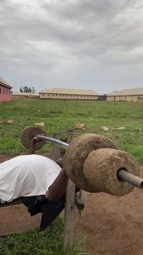 Man uses stone weights for outdoor workout in Nigeria
