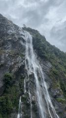 Waterfall documented flowing down vegetated mountain in Hồ Thầu, Vietnam