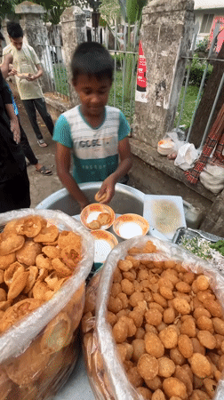 Young vendor serves pani puri at Dhaka street stall