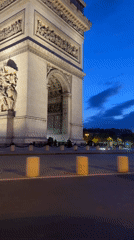 Evening scene captured at illuminated Arc de Triomphe, Paris
