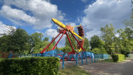 Amusement park ride operates in Brest, Belarus amid floral displays