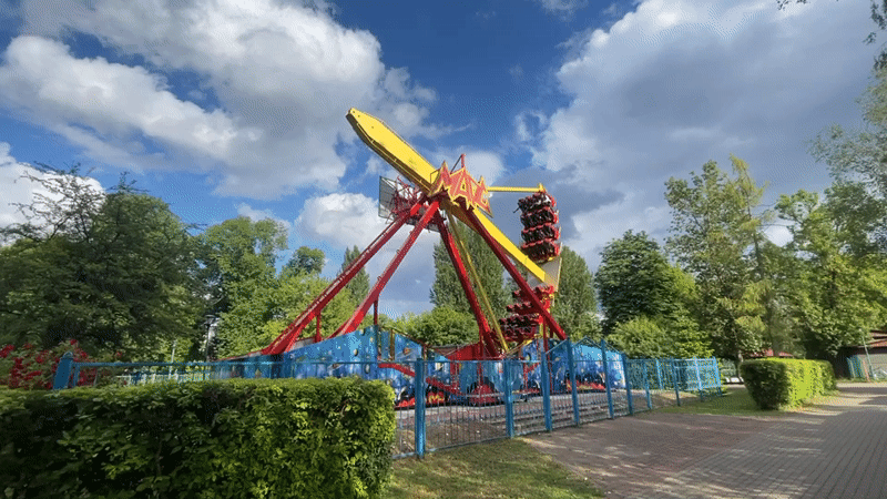 Amusement park ride operates in Brest, Belarus amid floral displays