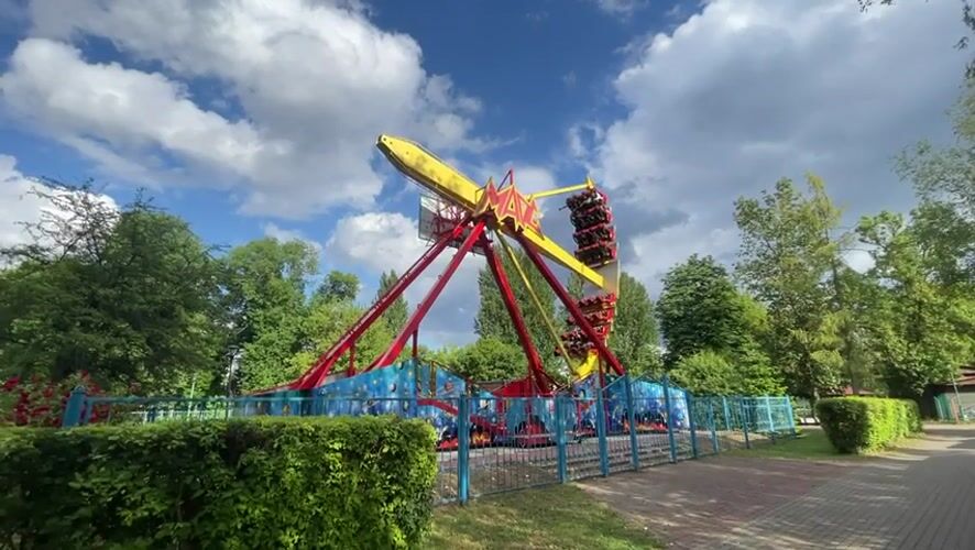 Amusement park ride operates in Brest, Belarus amid floral displays