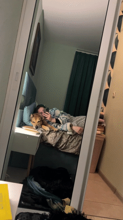 Woman and dog rest together on furniture in Bulgaria