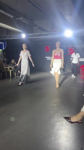Fashion show features models in white dresses in Tri Protoka