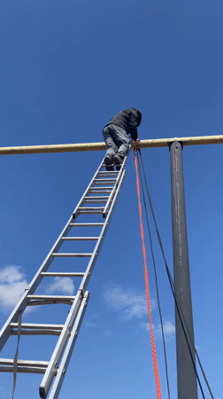 Man climbs ladder to reach elevated bar in Sarapul